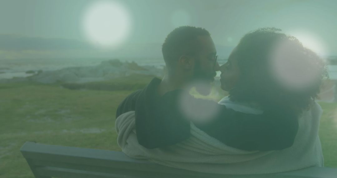 Romantic Embrace of Couple with Soothing Light Flare Over Ocean