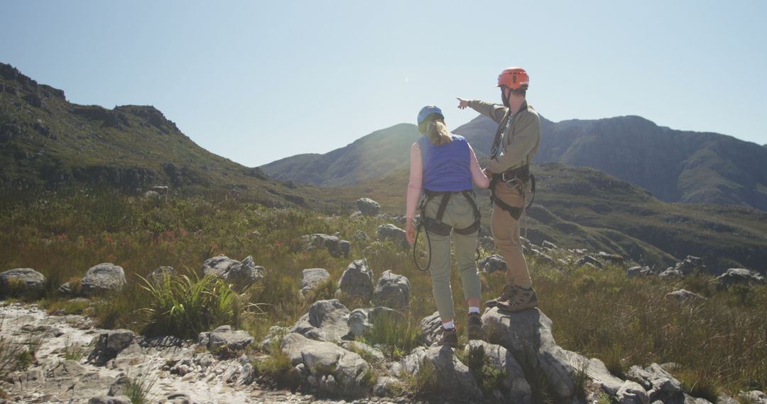 Adventurous Couple Hiking in Mountain Landscape on Sunny Day - Free Images, Stock Photos and Pictures on Pikwizard.com