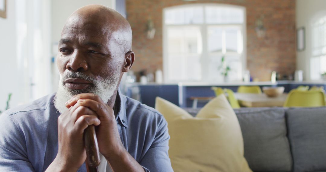 Elderly African American Man Contemplating in Modern Living Room - Free Images, Stock Photos and Pictures on Pikwizard.com