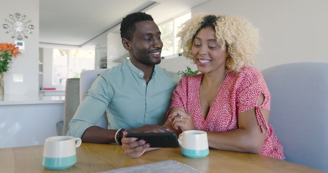 Joyful Couple Laughing Together Viewing Smartphone