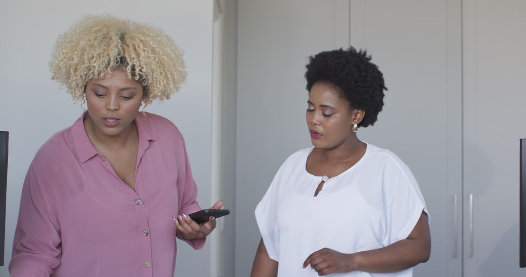 Women Collaborating on Project in Home Office Setting