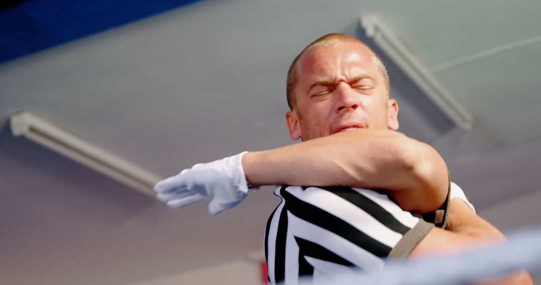 Sport referee sneezing during game with eyes closed and covering arm - Free Images, Stock Photos and Pictures on Pikwizard.com