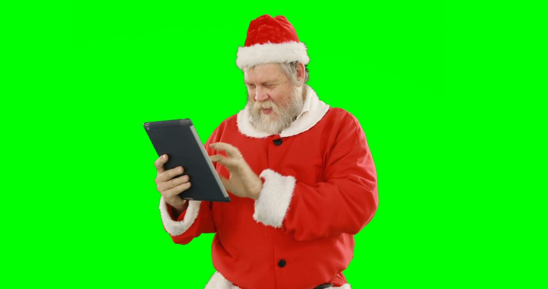 Santa Claus Using a Digital Tablet with Green Screen - Free Images, Stock Photos and Pictures on Pikwizard.com