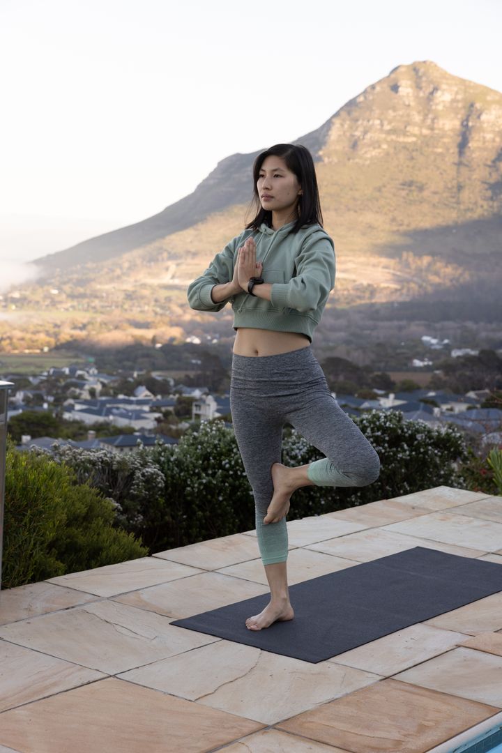Woman Practicing Yoga Tree Pose in Scenic Mountain Setting