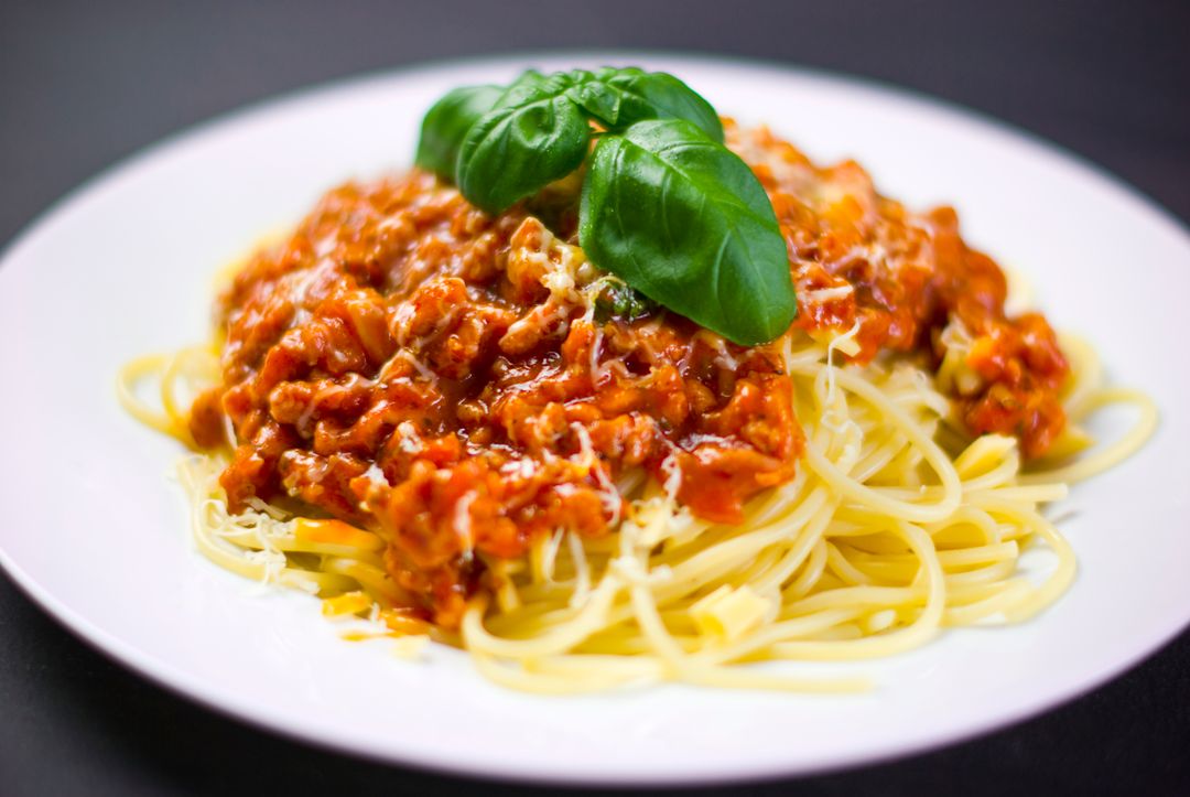 Delicious Spaghetti Bolognese Dish with Basil Garnish - Free Images, Stock Photos and Pictures on Pikwizard.com