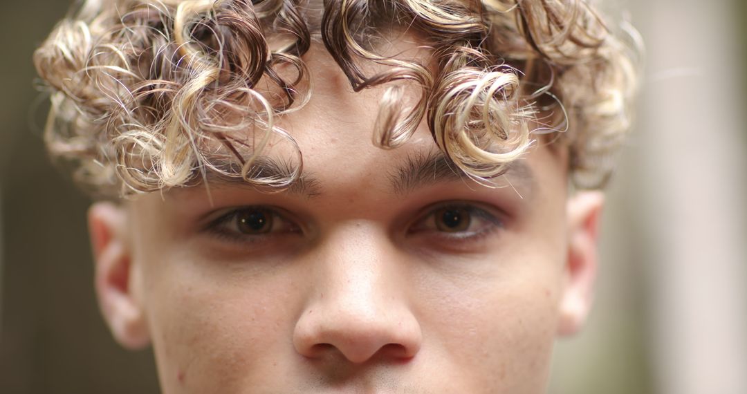 Close-Up Portrait of Young Man with Highlighted Curls