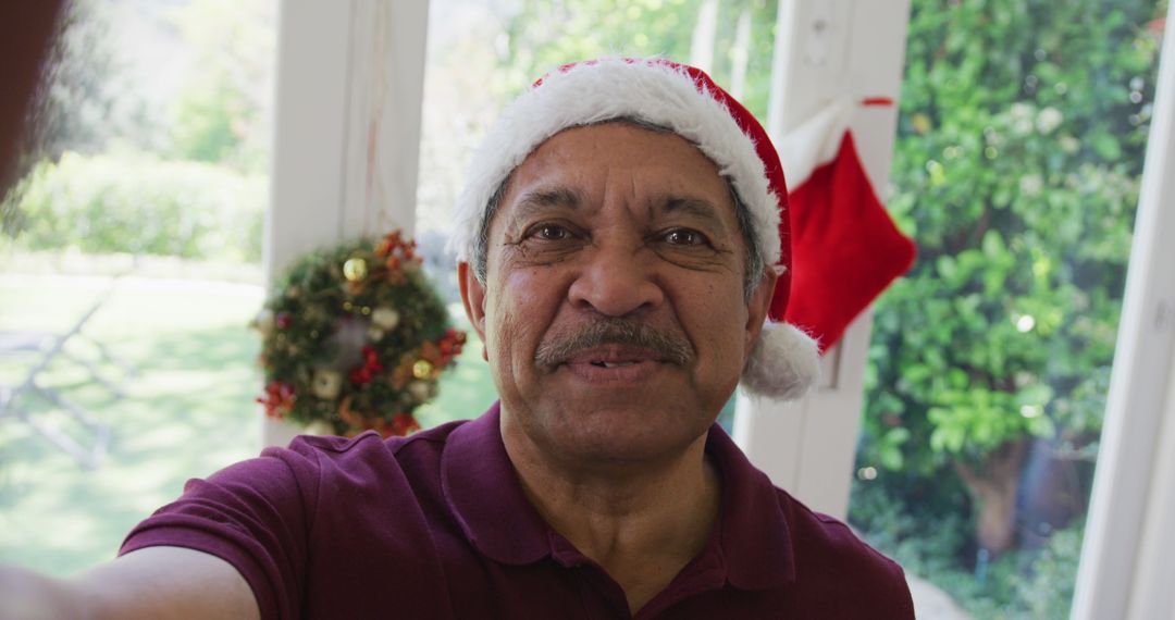 Smiling Senior Man Celebrating Christmas Indoors - Free Images, Stock Photos and Pictures on Pikwizard.com