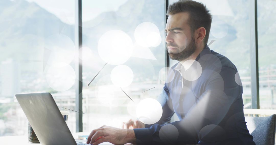Focused Man Working at Office Desk Next to Panoramic Windows