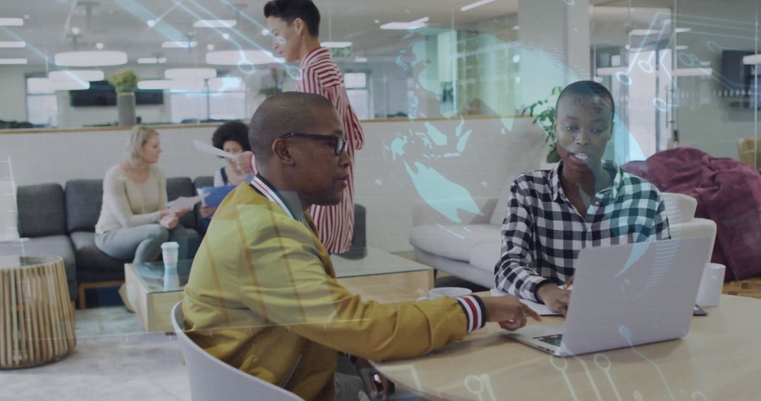 Coworkers Discussing Project During Collaborative Meeting in Modern Office Lounge