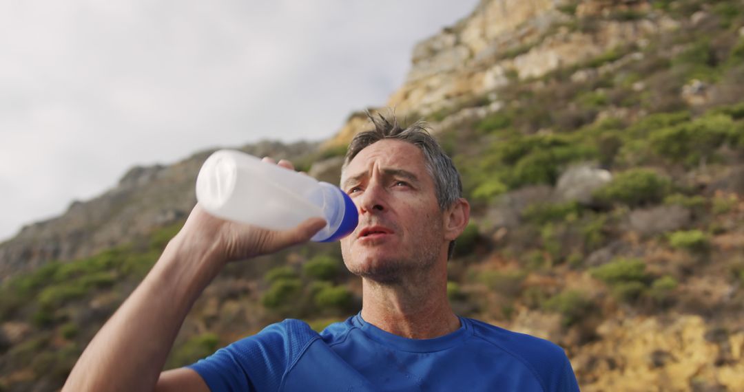 Man Drinking Water During Outdoor Fitness Activity - Free Images, Stock Photos and Pictures on Pikwizard.com