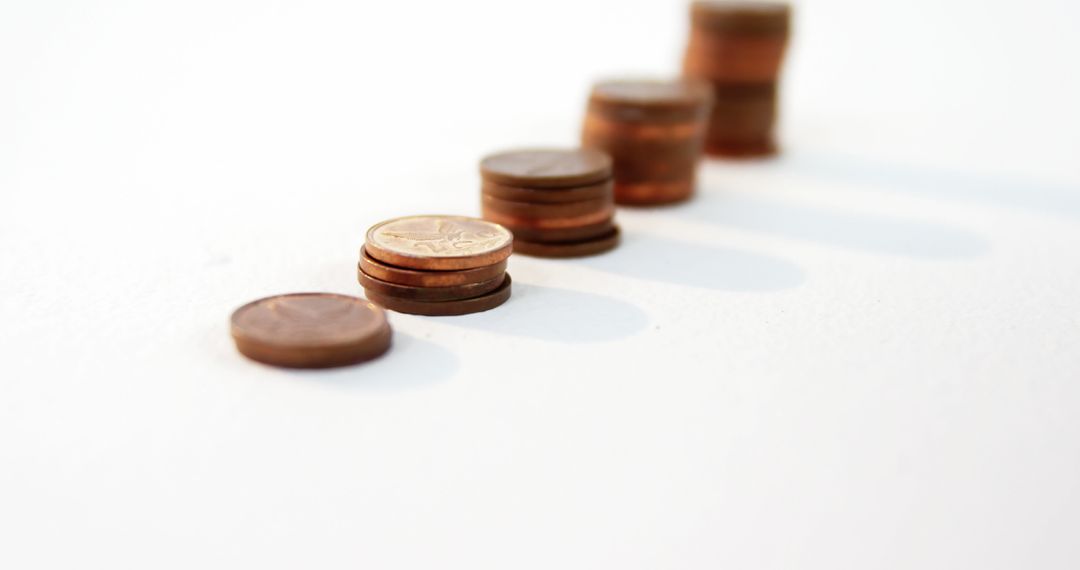 Increasing Stacks of Coins on White Background Showing Wealth Accumulation - Free Images, Stock Photos and Pictures on Pikwizard.com