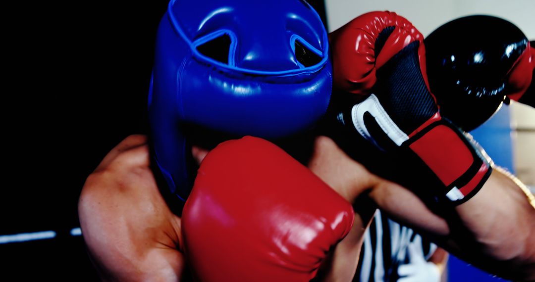 Boxer in Blue Headgear Blocking Punch in Training Session - Free Images, Stock Photos and Pictures on Pikwizard.com