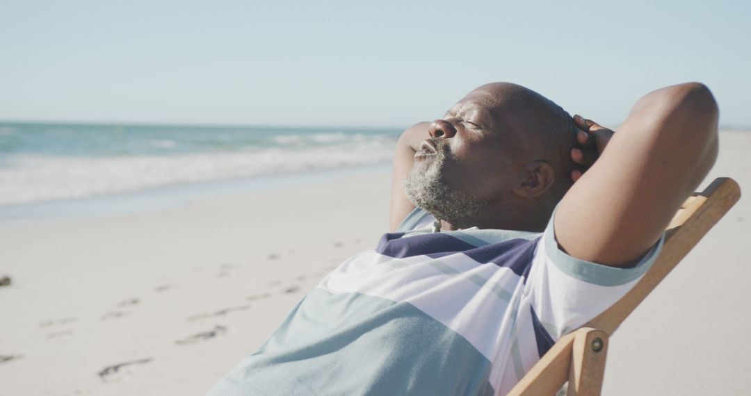 Relaxed Senior Man Sunbathing on Beach - Free Images, Stock Photos and Pictures on Pikwizard.com