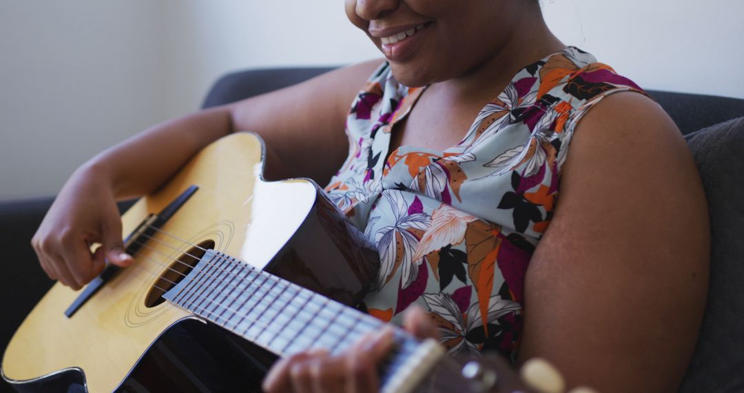 African American Woman Enjoying Playing Acoustic Guitar - Free Images, Stock Photos and Pictures on Pikwizard.com