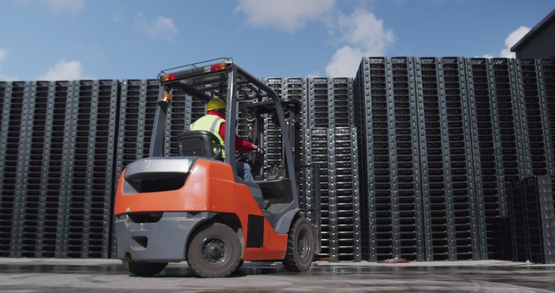 Worker Operating Forklift in Industrial Warehouse Yard with Stacked Containers - Free Images, Stock Photos and Pictures on Pikwizard.com