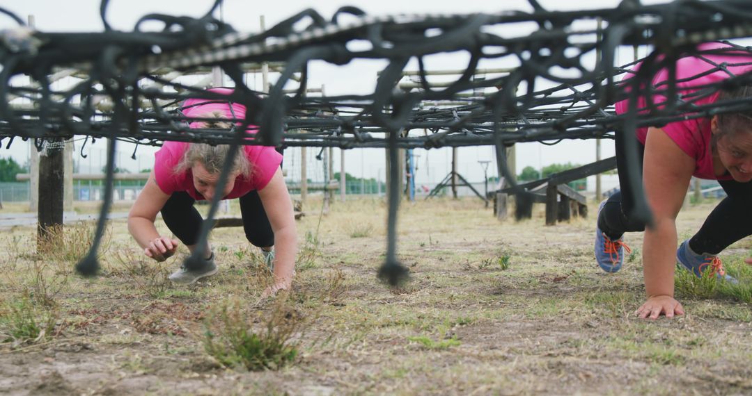 Women Crawling Under Net in Outdoor Obstacle Course - Free Images, Stock Photos and Pictures on Pikwizard.com