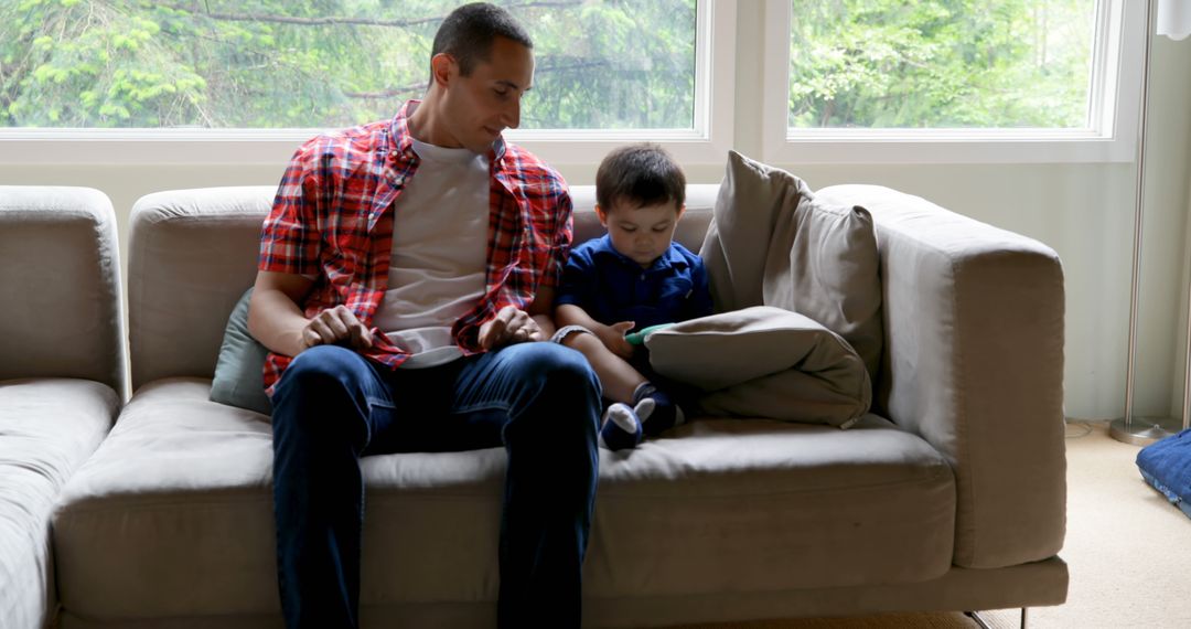 Father and Son Spending Quality Time on Couch - Free Images, Stock Photos and Pictures on Pikwizard.com