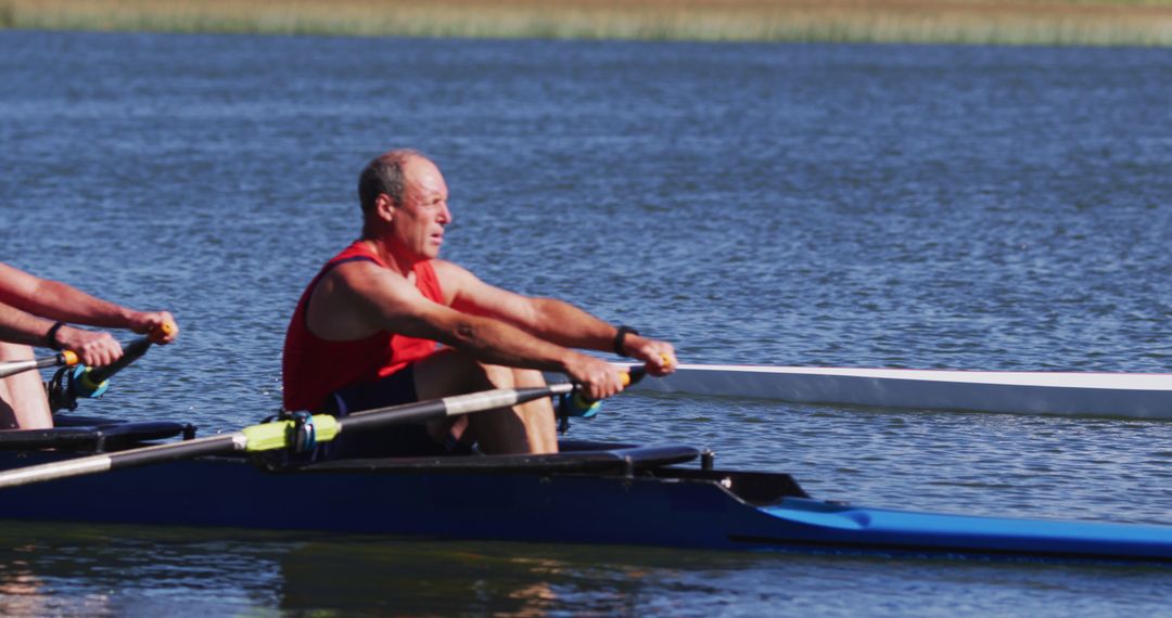 Senior Man Rowing in Blue Boat During Daytime Practice - Free Images, Stock Photos and Pictures on Pikwizard.com