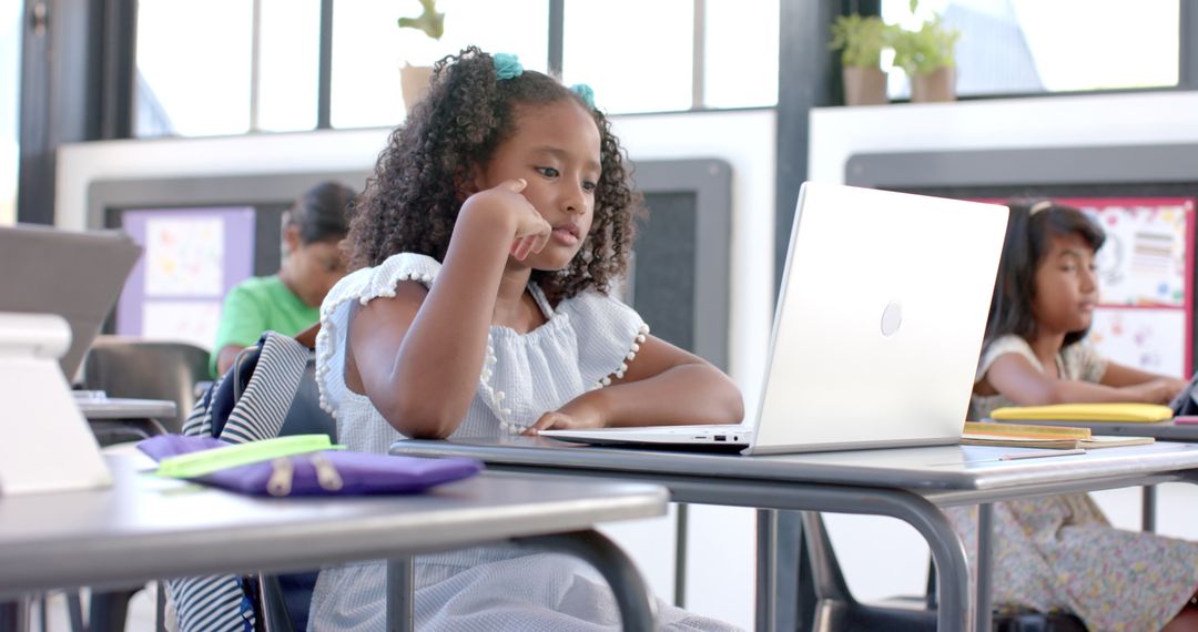 Young Student Engaged in Learning on Laptop in Classroom