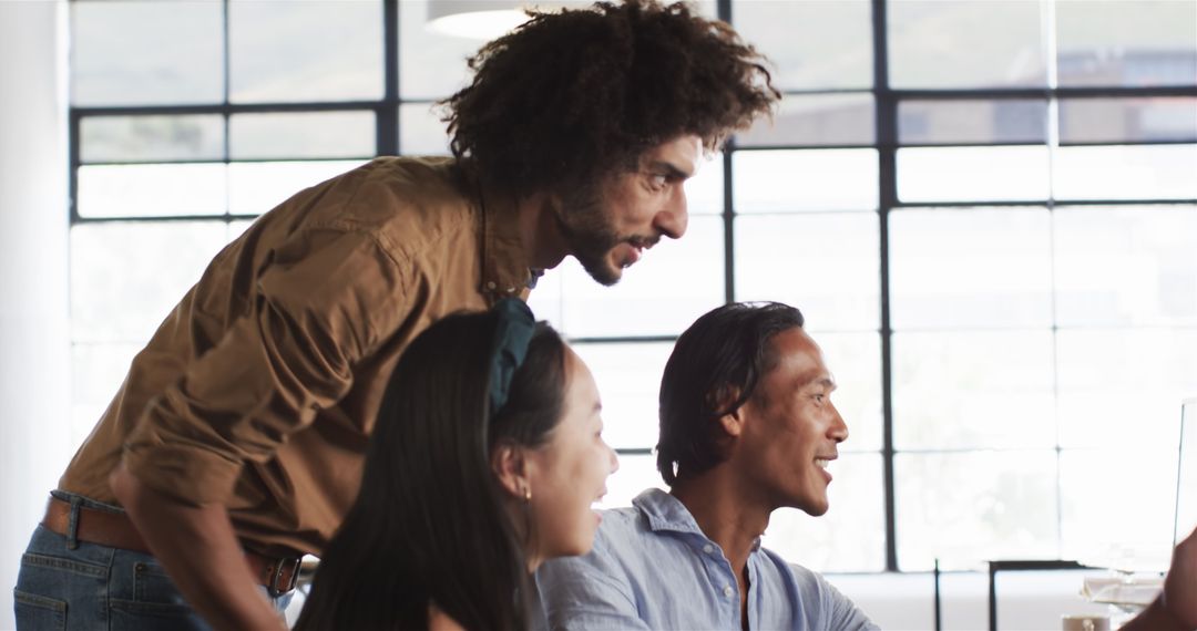 Diverse Colleagues Collaborating on Work in Modern Office