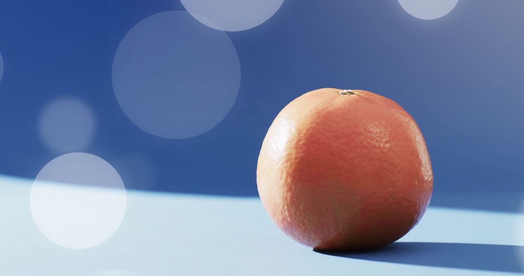 Fresh Orange on Blue Surface with Bokeh Lighting