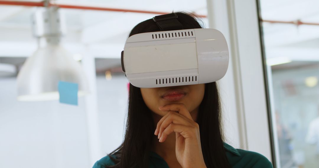 Young Woman Exploring Virtual Reality with VR Headset Indoors - Free Images, Stock Photos and Pictures on Pikwizard.com