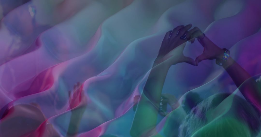 Heart Hands at Concert with Vibrant Neon Lights