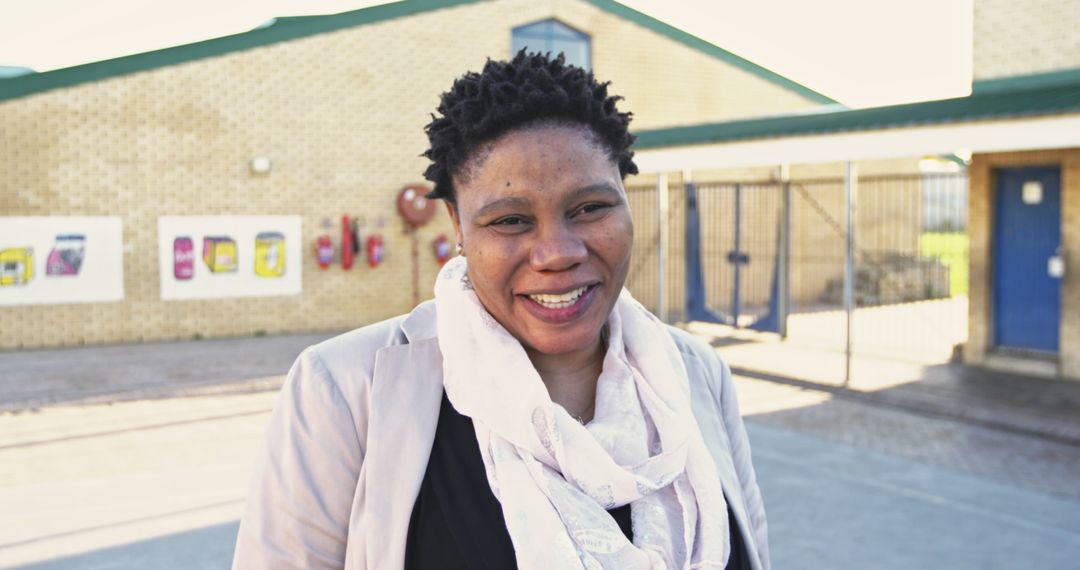 African School Teacher Smiling in Elementary Playground