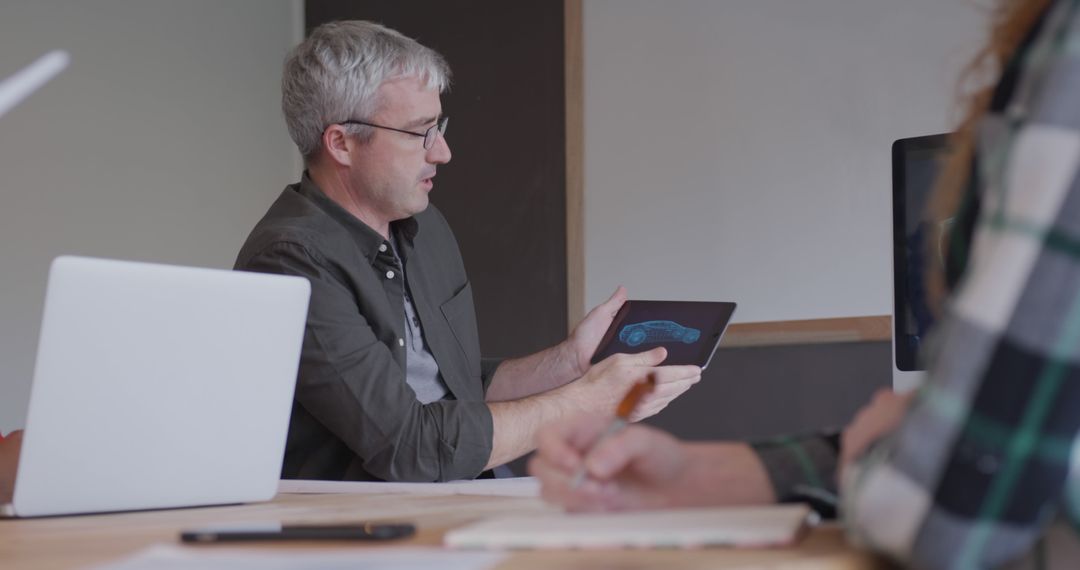 Engineer Discussing 3D Model on Tablet in Modern Meeting Room - Free Images, Stock Photos and Pictures on Pikwizard.com