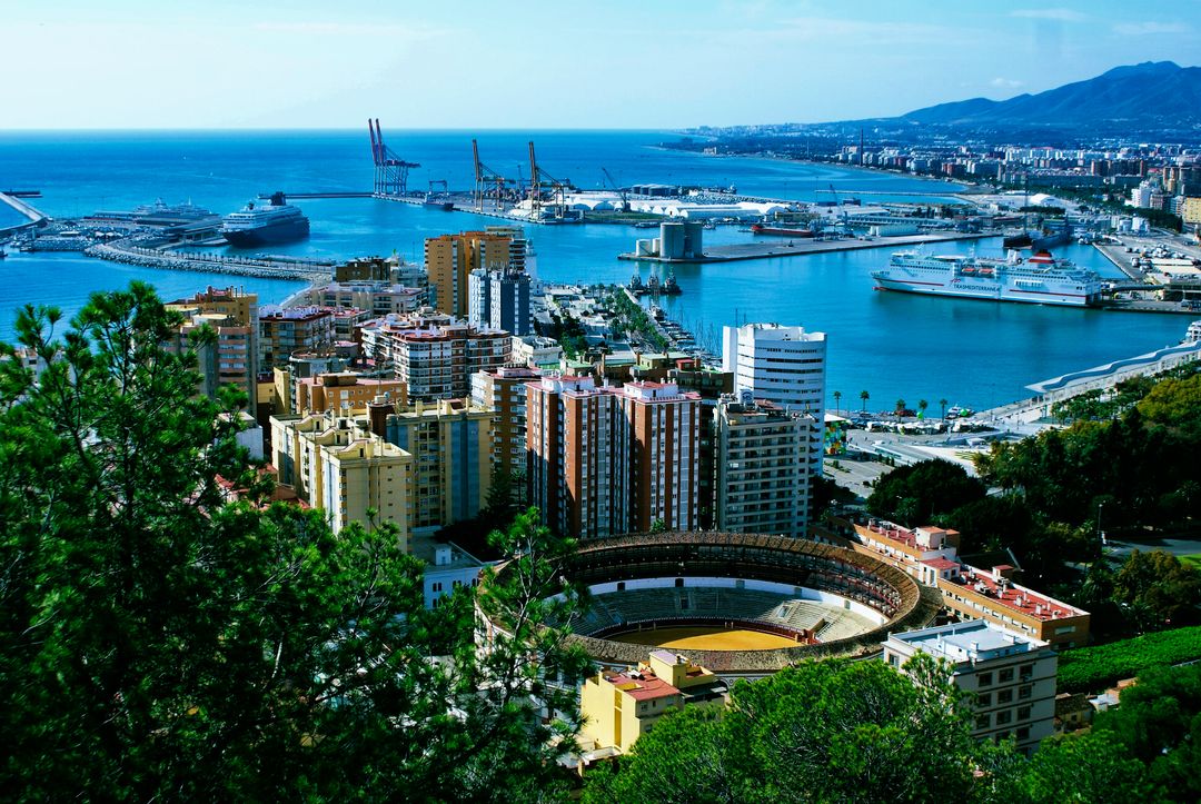 Panoramic View of Coastal City with Bullring and Modern Port - Free Images, Stock Photos and Pictures on Pikwizard.com