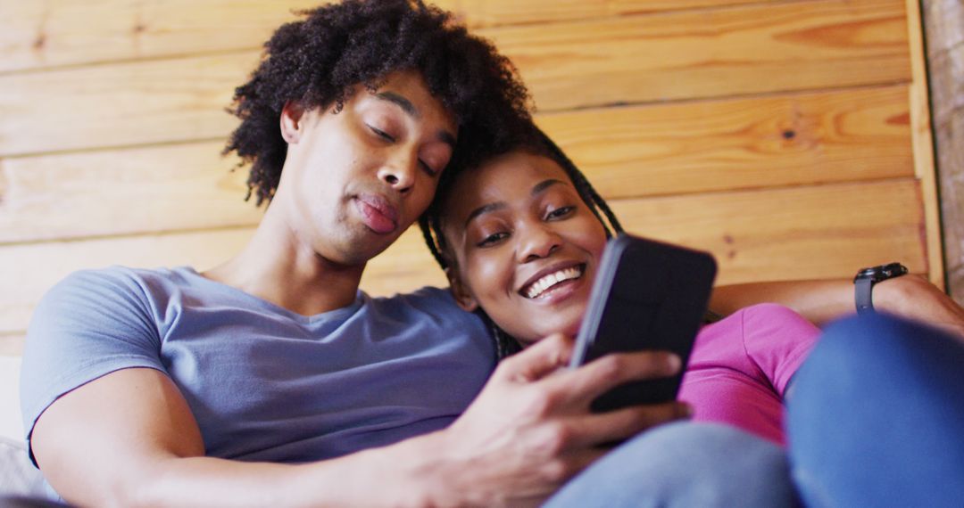 Couple Relaxing with Smartphone in Cozy Cabin - Free Images, Stock Photos and Pictures on Pikwizard.com