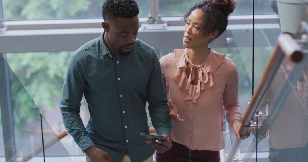 Diverse Business Professionals Discussing Ideas on Tablet