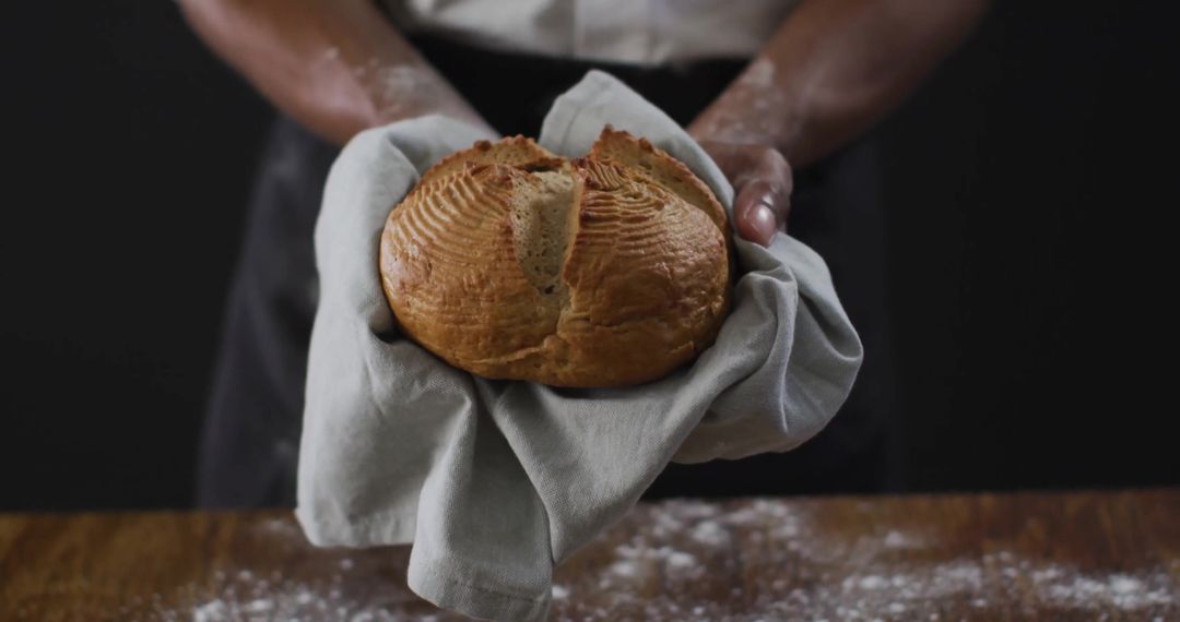 Flour-Dusted Hands Presenting Fresh Artisan Bread