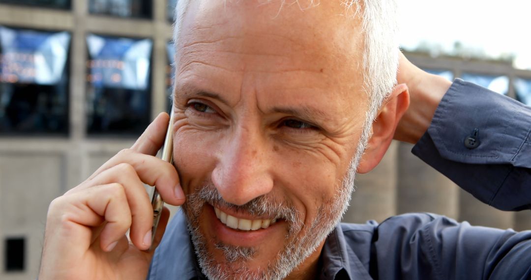 Smiling Senior Man Talking on Smartphone Outdoors - Free Images, Stock Photos and Pictures on Pikwizard.com