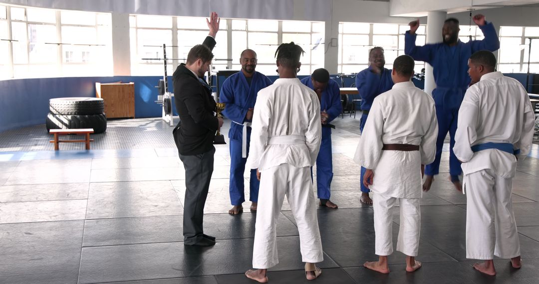 Judo Team Celebrates Victory with Trophy Presentation