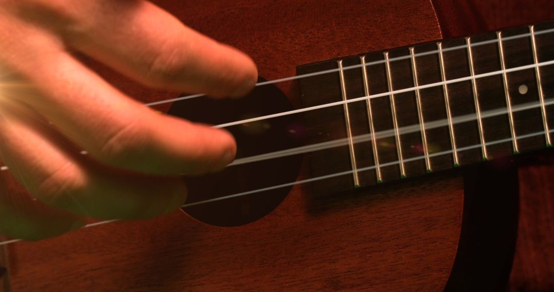 Guitar Strumming Close-Up with Warm Light Effect