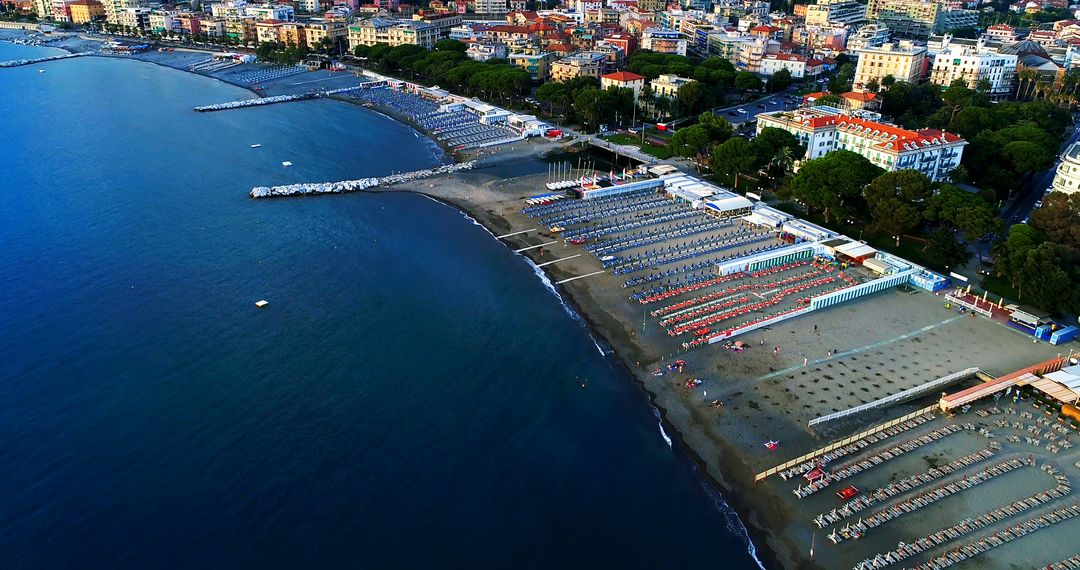 Aerial View of Coastal City with Sandy Beaches and Umbrella-Lined Shoreline - Free Images, Stock Photos and Pictures on Pikwizard.com