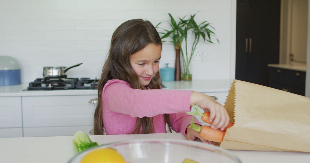 Smiling Girl Packing Fresh Vegetables in Kitchen - Free Images, Stock Photos and Pictures on Pikwizard.com