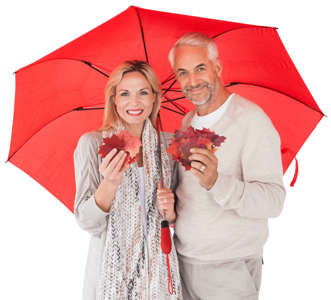 Smiling Couple Holding Leaves Under Transparent Red Umbrella