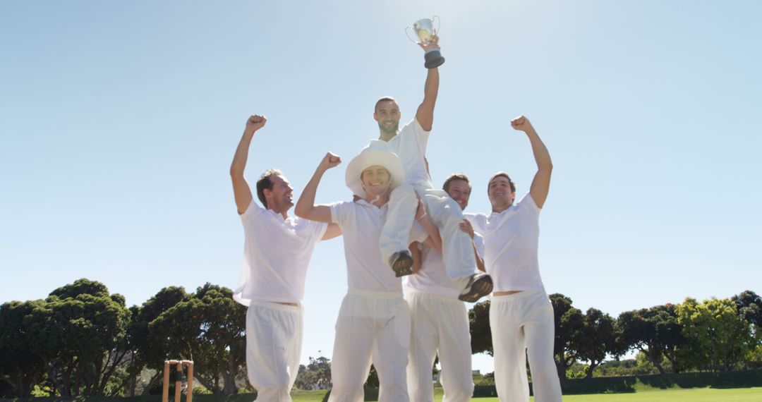 Cricket Team Celebrating Victory Holding Trophy - Free Images, Stock Photos and Pictures on Pikwizard.com