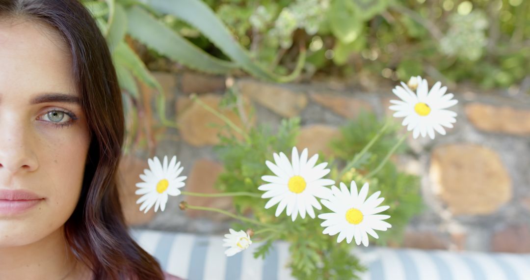 Woman Resting on Patio Surrounded by Blooms and Greenery
