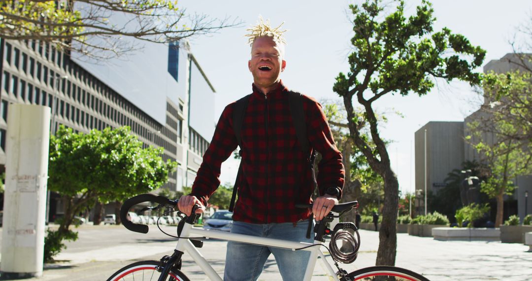 Joyful Albino Male with Bicycle in Urban Environment - Free Images, Stock Photos and Pictures on Pikwizard.com