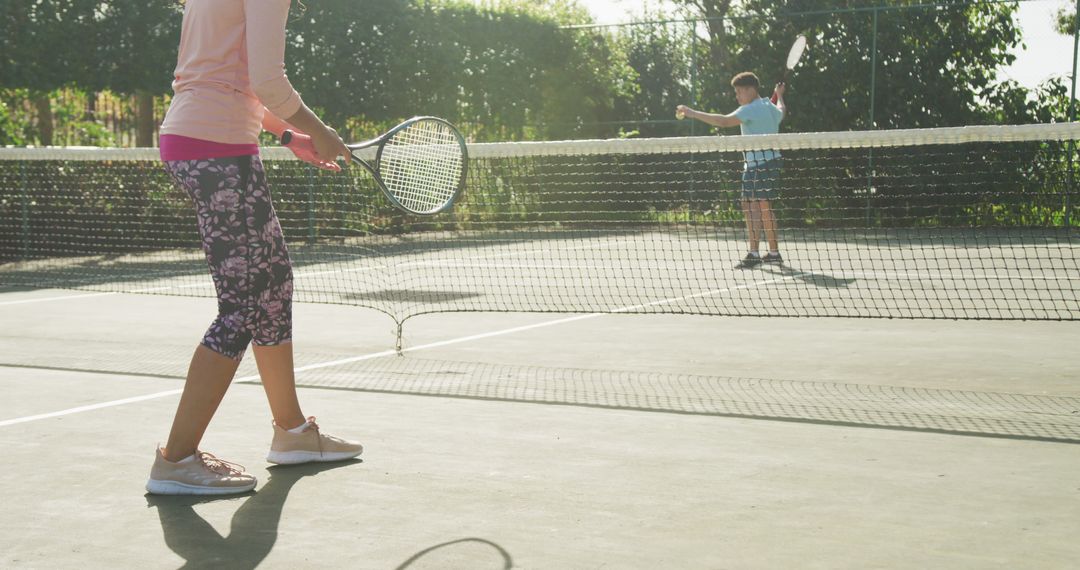 People Playing Tennis Outdoors on Sunny Day - Free Images, Stock Photos and Pictures on Pikwizard.com