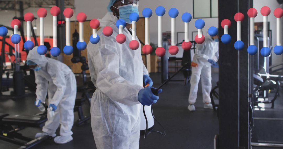 Sanitation Workers in Protective Gear Disinfecting Gym Environment