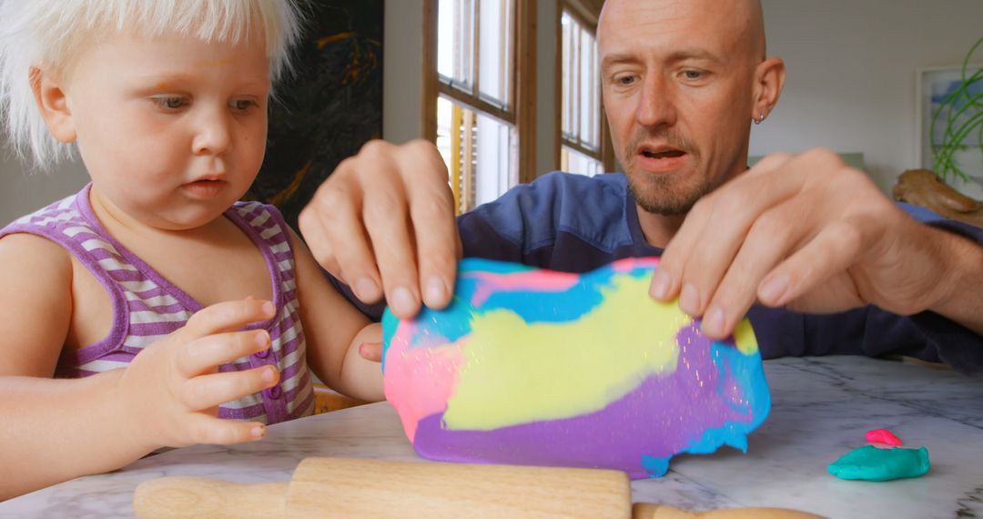 Father and Daughter Playing with Colorful Clay at Home