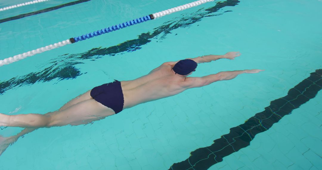 Male Swimmer Practicing Front Crawl in Indoor Pool - Free Images, Stock Photos and Pictures on Pikwizard.com