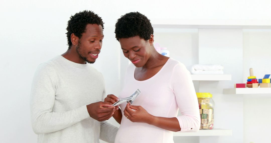 Expectant Parents Looking at Ultrasound Photo Together - Free Images, Stock Photos and Pictures on Pikwizard.com