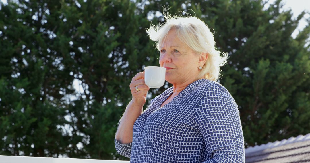 Senior Woman Enjoying Coffee Outdoors on a Sunny Day - Free Images, Stock Photos and Pictures on Pikwizard.com