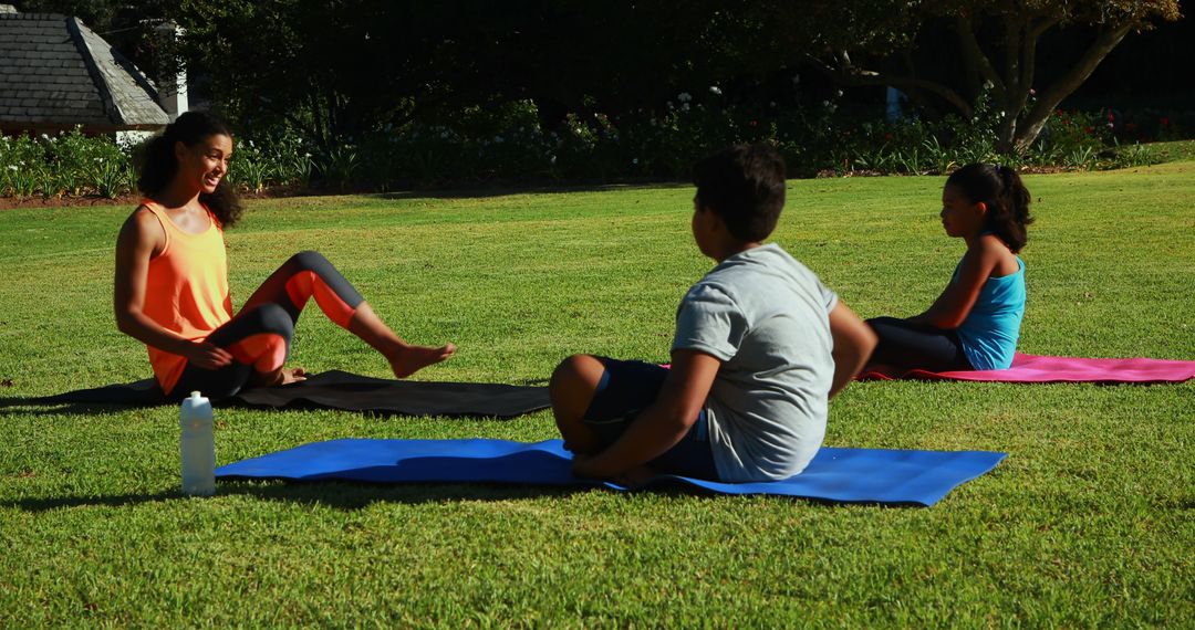 African American Mother and Children Doing Outdoor Yoga in Park - Free Images, Stock Photos and Pictures on Pikwizard.com