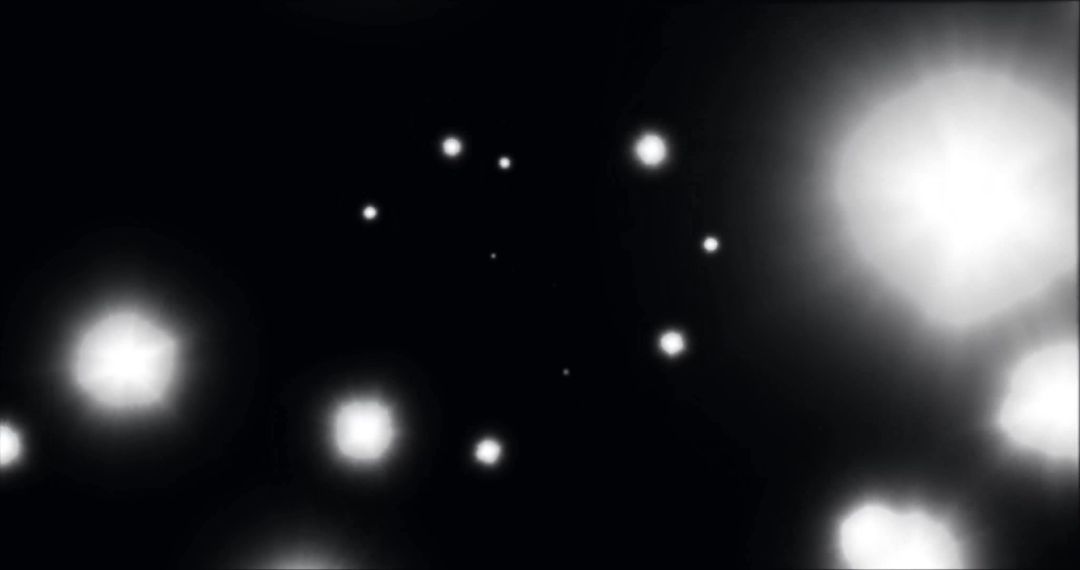 Glowing Light Spots Against Black Background